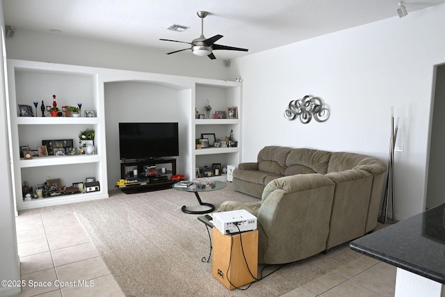 321 Brightwater Dr SE, Palm Bay, FL 32909 - living room with light tile patterned floors, built in shelves, and a ceiling fan
