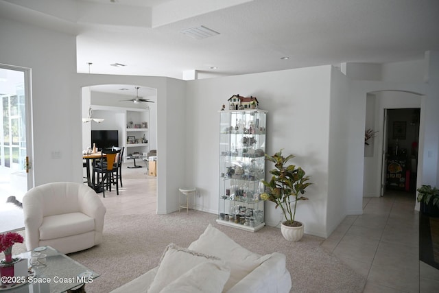 321 Brightwater Dr SE, Palm Bay, FL 32909 - living area featuring arched walkways, tile patterned flooring, and a ceiling fan