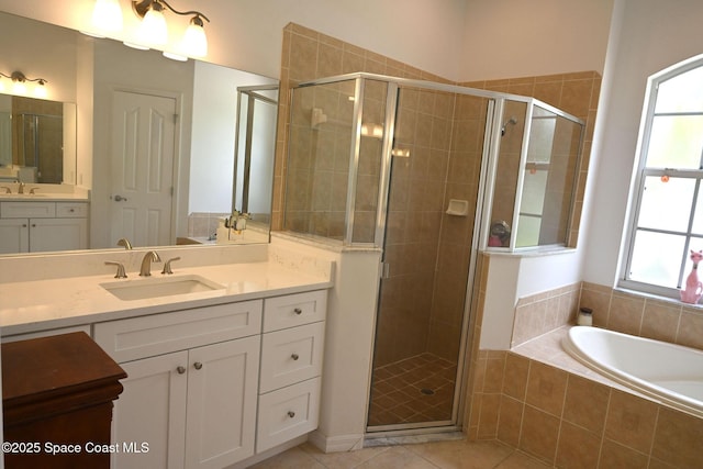 321 Brightwater Dr SE, Palm Bay, FL 32909 - full bathroom featuring a stall shower, vanity, a garden tub, and tile patterned floors