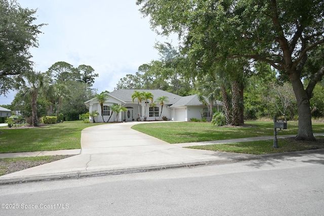 321 Brightwater Dr SE, Palm Bay, FL 32909 - view of front of home featuring a front lawn, a garage, concrete driveway, and stucco siding