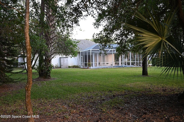 321 Brightwater Dr SE, Palm Bay, FL 32909 - view of green lawn with glass enclosure