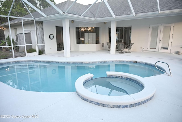 321 Brightwater Dr SE, Palm Bay, FL 32909 - view of pool with a pool with connected hot tub, a patio area, glass enclosure, and french doors