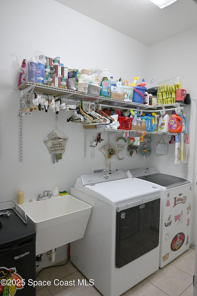 321 Brightwater Dr SE, Palm Bay, FL 32909 - laundry room with washer and dryer and light tile patterned flooring