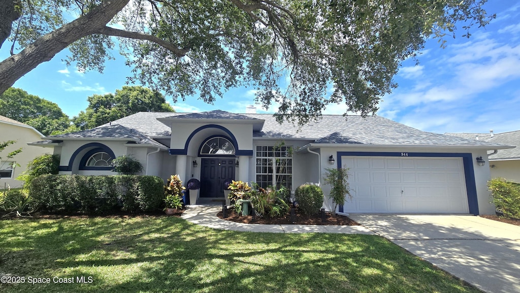 ranch-style house featuring a garage, stucco siding, concrete driveway, and a front lawn