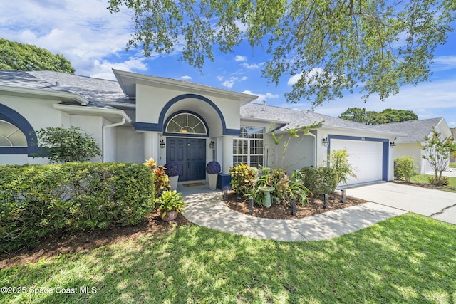 944 Osprey Ln, Rockledge, FL 32955 - ranch-style home with an attached garage, stucco siding, concrete driveway, a shingled roof, and a front yard