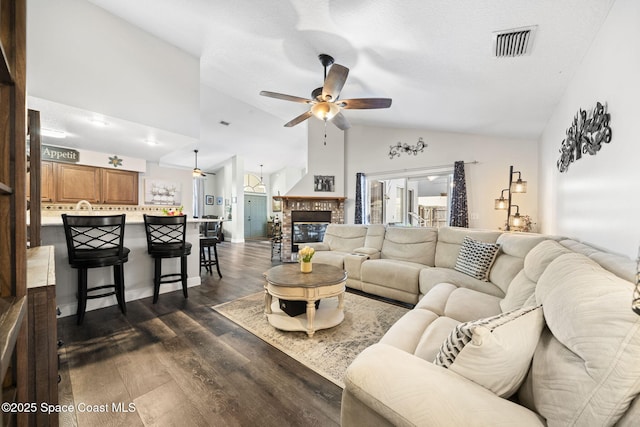 944 Osprey Ln, Rockledge, FL 32955 - living area featuring a ceiling fan, lofted ceiling, dark wood-type flooring, and a brick fireplace