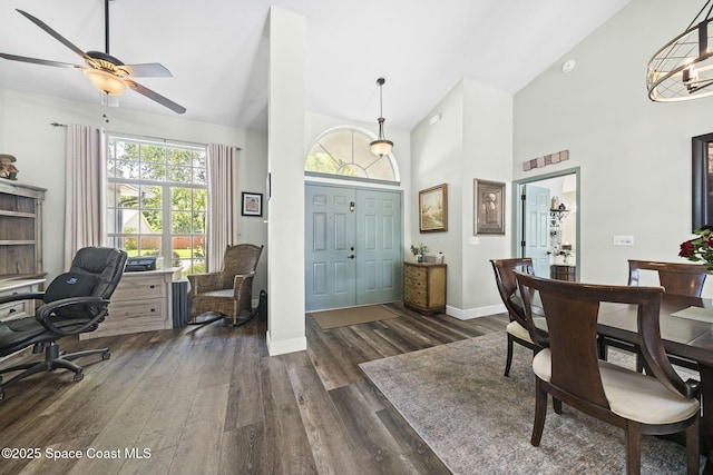 944 Osprey Ln, Rockledge, FL 32955 - home office with dark wood-style flooring, high vaulted ceiling, baseboards, a ceiling fan, and a chandelier