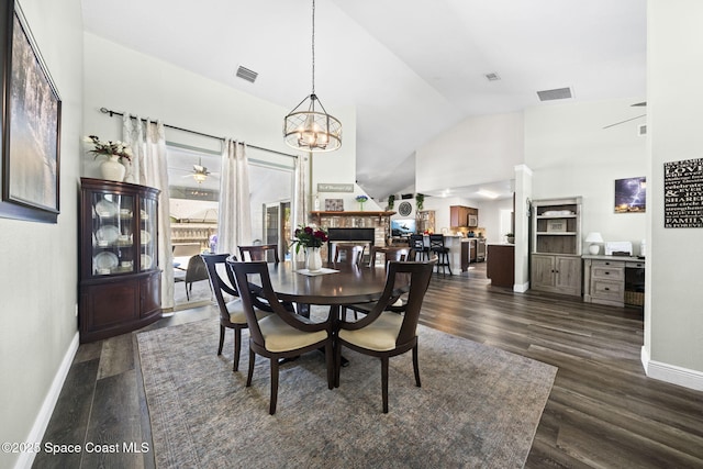944 Osprey Ln, Rockledge, FL 32955 - dining space with baseboards, high vaulted ceiling, dark wood-type flooring, and a chandelier