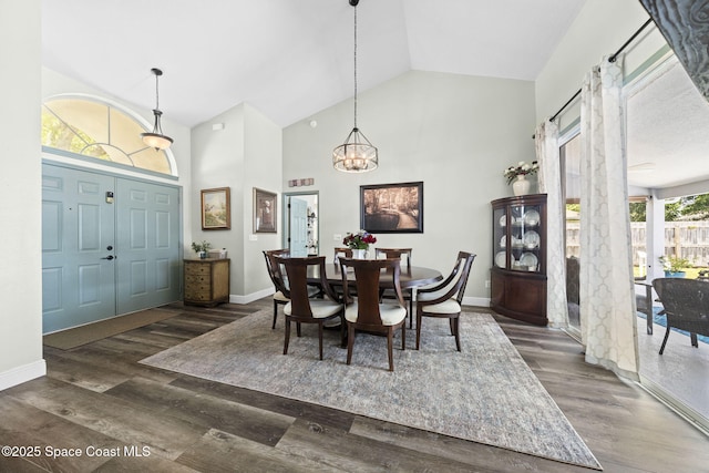 944 Osprey Ln, Rockledge, FL 32955 - dining room with high vaulted ceiling, a chandelier, baseboards, and wood finished floors