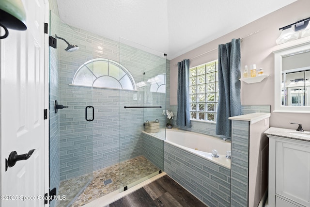 944 Osprey Ln, Rockledge, FL 32955 - full bath featuring a shower stall, vanity, a bath, and wood finished floors