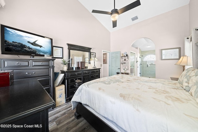 944 Osprey Ln, Rockledge, FL 32955 - bedroom with dark wood finished floors, arched walkways, high vaulted ceiling, a ceiling fan, and ensuite bathroom