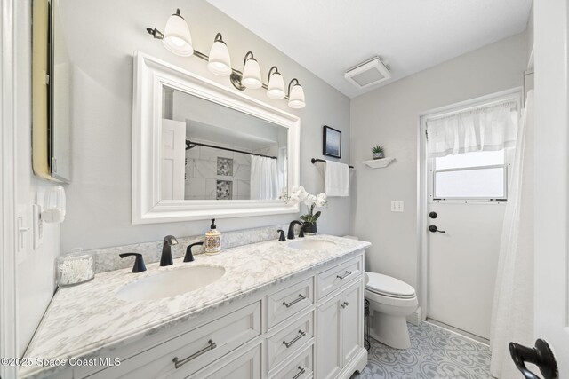 944 Osprey Ln, Rockledge, FL 32955 - bathroom featuring toilet and double vanity