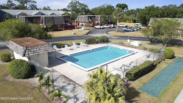 pool with fence and a patio