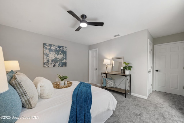 carpeted bedroom with a ceiling fan, baseboards, and visible vents