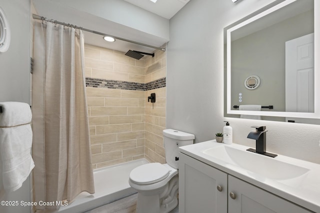 bathroom with vanity, a stall shower, and toilet