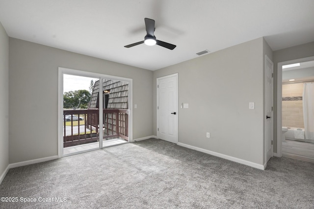 carpeted spare room with ceiling fan, visible vents, and baseboards