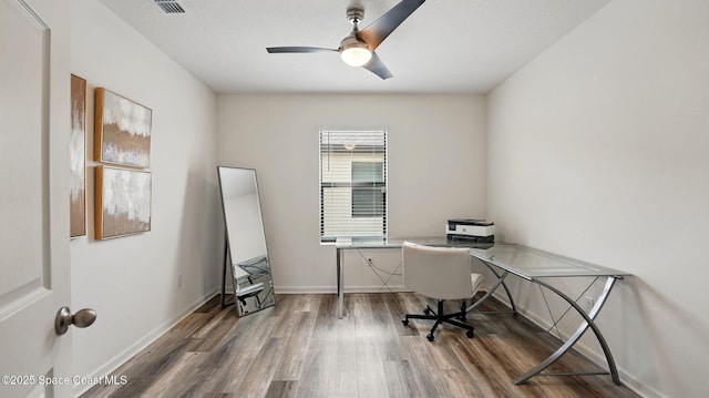 office area featuring wood finished floors, a ceiling fan, and baseboards