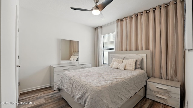 bedroom featuring wood finished floors, baseboards, and ceiling fan