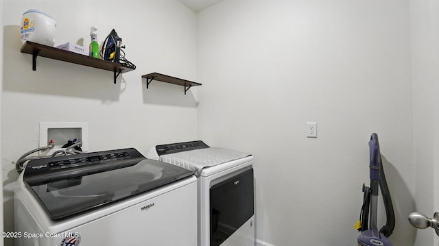 clothes washing area with washer and clothes dryer and baseboards
