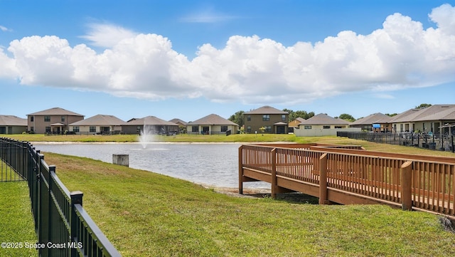 dock area featuring a water view and a residential view