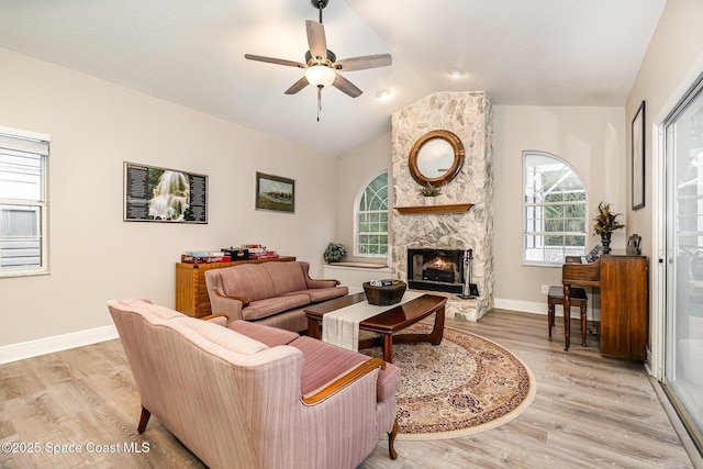 7703 Windover Way, Titusville, FL 32780 - living room with a fireplace, a ceiling fan, light wood finished floors, and lofted ceiling