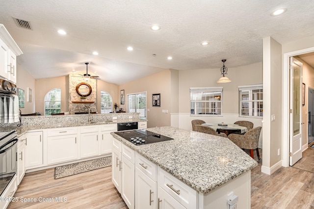 7703 Windover Way, Titusville, FL 32780 - kitchen with ceiling fan, visible vents, light wood finished floors, and black appliances