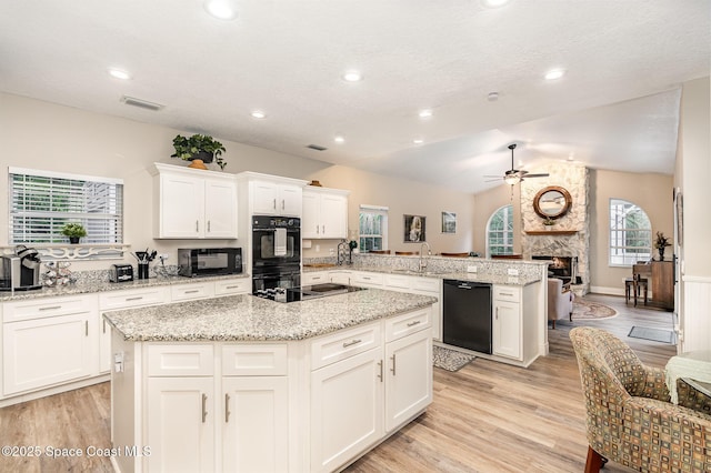 7703 Windover Way, Titusville, FL 32780 - kitchen featuring a sink, a ceiling fan, a peninsula, visible vents, and black appliances