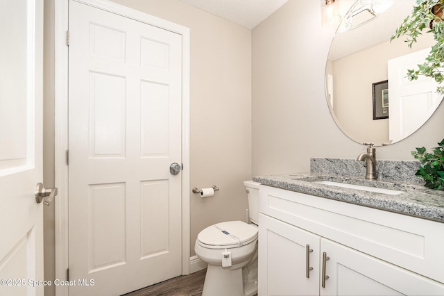 7703 Windover Way, Titusville, FL 32780 - bathroom with toilet, wood finished floors, and vanity