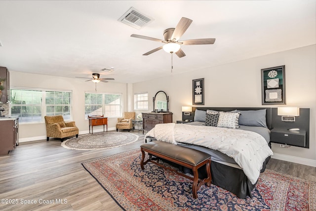7703 Windover Way, Titusville, FL 32780 - bedroom with a ceiling fan, baseboards, visible vents, and wood finished floors
