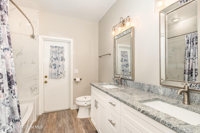 7703 Windover Way, Titusville, FL 32780 - full bathroom featuring double vanity, a sink, wood finished floors, and toilet