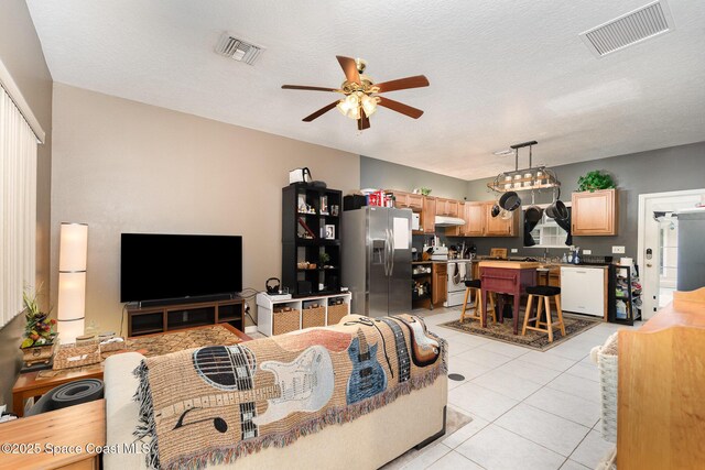7703 Windover Way, Titusville, FL 32780 - living area with ceiling fan, light tile patterned flooring, and visible vents