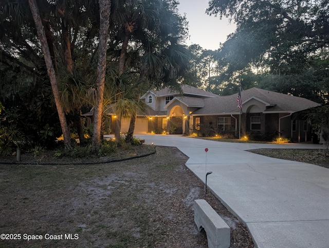 7703 Windover Way, Titusville, FL 32780 - traditional-style home featuring curved driveway