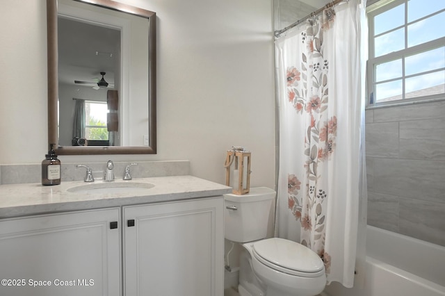 bathroom with plenty of natural light, a ceiling fan, toilet, and vanity