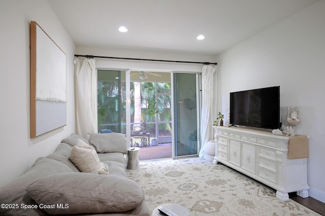 living room featuring recessed lighting, a ceiling fan, and wood finished floors