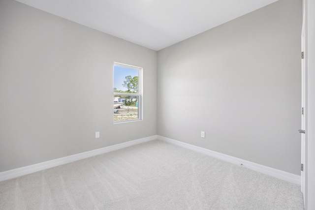 carpeted spare room with baseboards