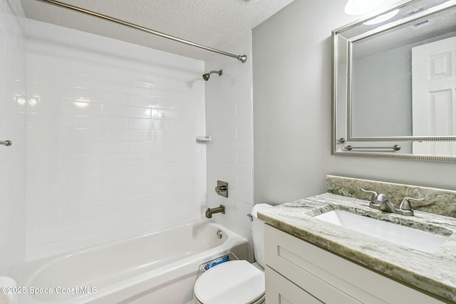 full bathroom with vanity, toilet,  shower combination, and a textured ceiling