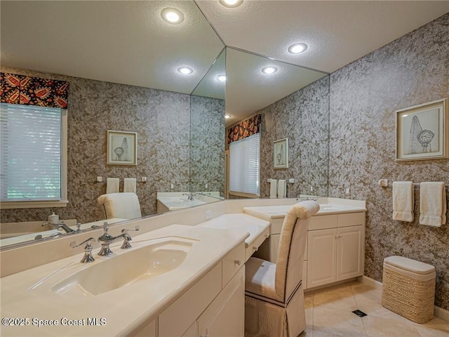 120 N White Jewel Ct, Vero Beach, FL 32963 - bathroom with a washtub, tile patterned flooring, and vanity