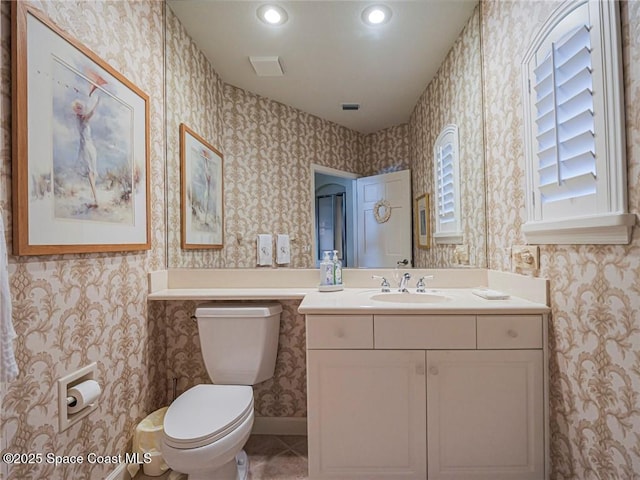 120 N White Jewel Ct, Vero Beach, FL 32963 - bathroom with vanity, tile patterned flooring, toilet, wallpapered walls, and recessed lighting