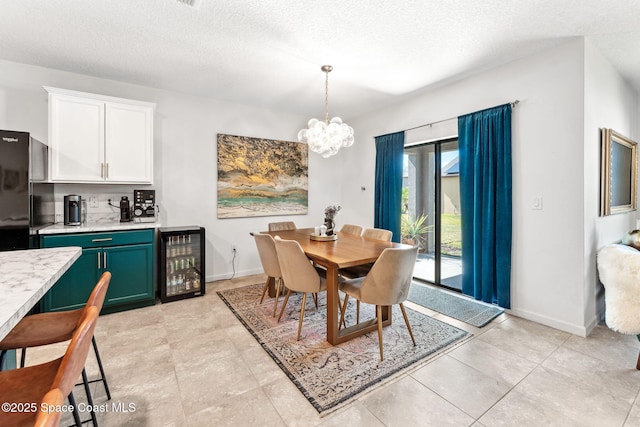 5985 Orsino Ln, Cocoa, FL 32926 - dining area with wine cooler, a textured ceiling, a chandelier, bar, and baseboards
