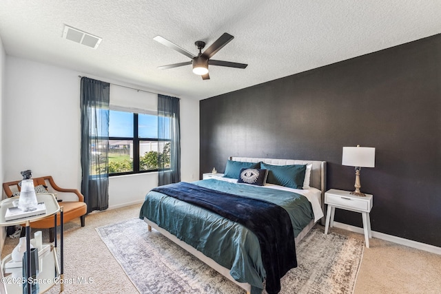 5985 Orsino Ln, Cocoa, FL 32926 - bedroom with carpet flooring, a textured ceiling, baseboards, and a ceiling fan