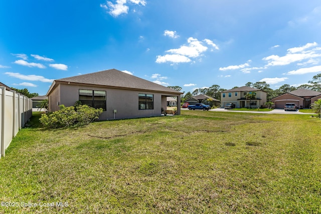 5985 Orsino Ln, Cocoa, FL 32926 - rear view of house featuring stucco siding and fence