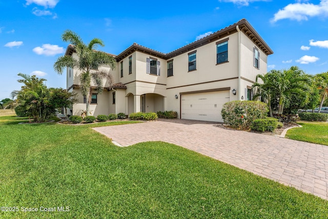 7773 Desmond Ave, Melbourne, FL 32940 - mediterranean / spanish house featuring a garage, decorative driveway, a front lawn, and stucco siding