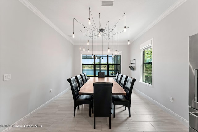7773 Desmond Ave, Melbourne, FL 32940 - dining room with a chandelier, ornamental molding, and baseboards