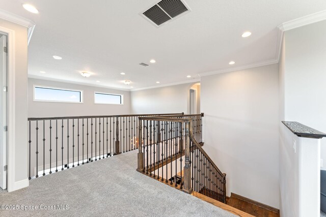 7773 Desmond Ave, Melbourne, FL 32940 - hall featuring an upstairs landing, arched walkways, recessed lighting, ornamental molding, and carpet flooring