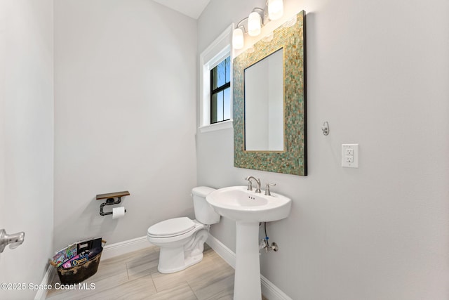 7773 Desmond Ave, Melbourne, FL 32940 - half bathroom featuring baseboards and toilet