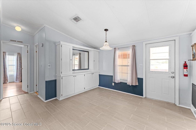 8865 Central Ave, Micco, FL 32976 - unfurnished dining area with crown molding, lofted ceiling, plenty of natural light, and baseboards