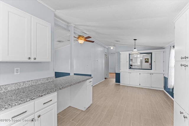8865 Central Ave, Micco, FL 32976 - kitchen featuring ornamental molding, white cabinets, a ceiling fan, light stone counters, and hanging light fixtures