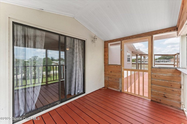 8865 Central Ave, Micco, FL 32976 - unfurnished sunroom featuring lofted ceiling, hardwood / wood-style floors, and wooden walls