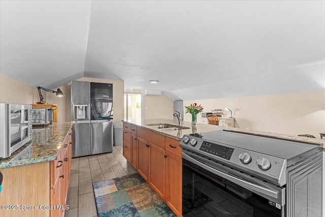 8865 Central Ave, Micco, FL 32976 - kitchen with stainless steel appliances, a sink, vaulted ceiling, light stone countertops, and wood finish floors