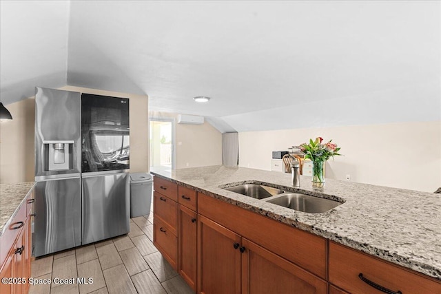 8865 Central Ave, Micco, FL 32976 - kitchen featuring a sink, vaulted ceiling, brown cabinets, light stone counters, and a wall mounted AC